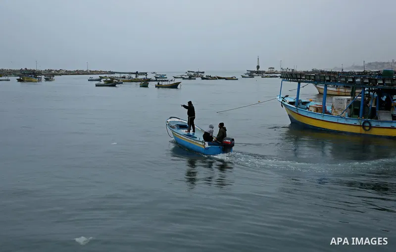 Palestinian fishermen work on their fishing boats at the port in Gaza City on February 26, 2018. A spokeswoman for the Israeli army said the boat "deviated from the designated fishing zone in the northern Gaza Strip. "Na...