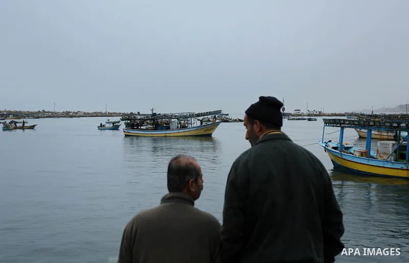Palestinian fishermen work on their fishing boats at the port in Gaza City on February 26, 2018. A spokeswoman for the Israeli army said the boat "deviated from the designated fishing zone in the northern Gaza Strip. "Na...