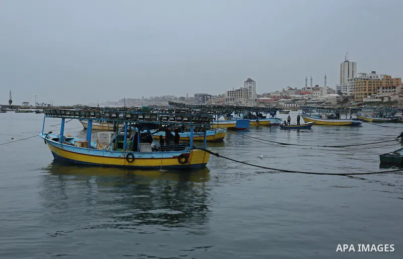 Palestinian fishermen work on their fishing boats at the port in Gaza City on February 26, 2018. A spokeswoman for the Israeli army said the boat "deviated from the designated fishing zone in the northern Gaza Strip. "Na...