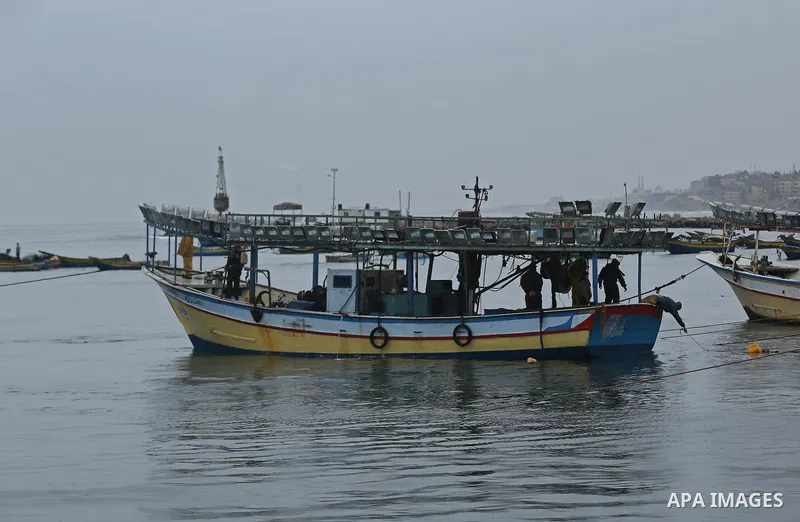 Palestinian fishermen work on their fishing boats at the port in Gaza City on February 26, 2018. A spokeswoman for the Israeli army said the boat "deviated from the designated fishing zone in the northern Gaza Strip. "Na...