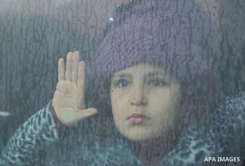 A Palestinian girl looks throuth a car window in Gaza City on February 26, 2018. Photo by Ashraf Amra