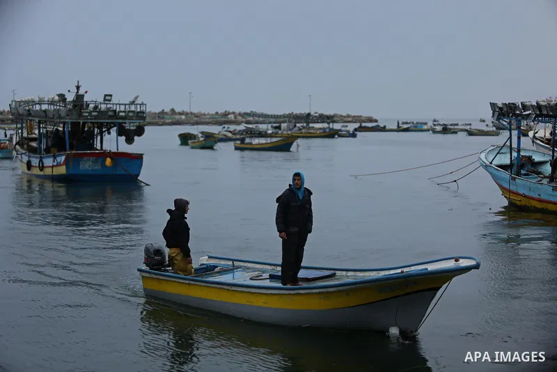Palestinian fishermen work on their fishing boats at the port in Gaza City on February 26, 2018. A spokeswoman for the Israeli army said the boat "deviated from the designated fishing zone in the northern Gaza Strip. "Na...