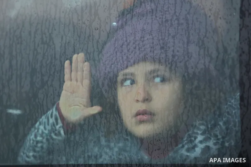 A Palestinian girl looks throuth a car window in Gaza City on February 26, 2018. Photo by Ashraf Amra