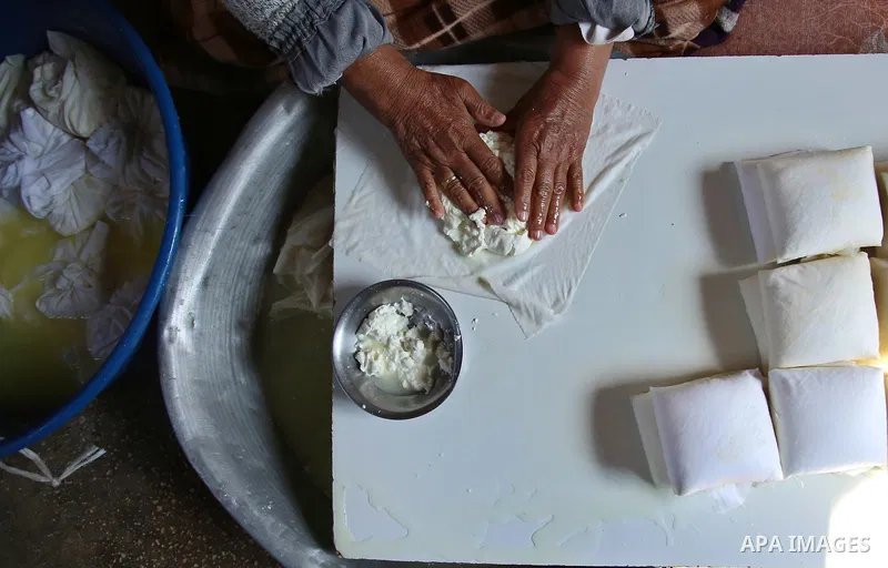 An elderly Palestinian woman Hayat Zeid , 80, makes templates of white cheese inside her home, in Kfairet village near the West Bank city of Jenin, on Febraruy 24, 2018. Hayat has been making cheese from sheep milk since...