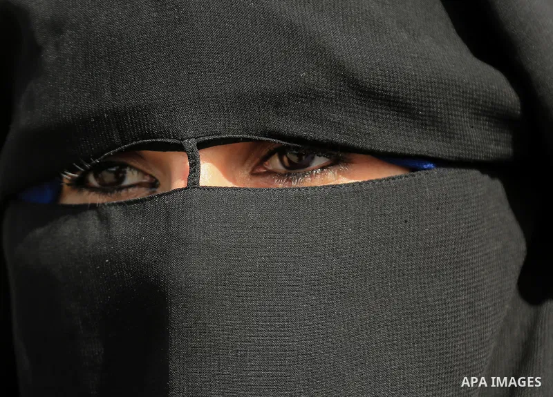 A Palestinian woman wearing veils looks on a protest calling for an end to the power crisis, outside the power plant in the central Gaza Strip on February 27, 2018. Photo by Dawoud Abo Alkas