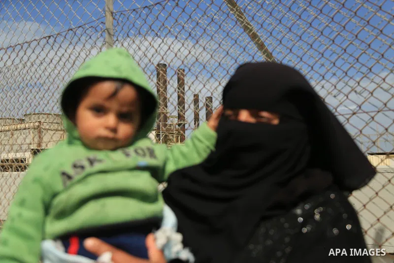 A Palestinian woman holds her son during a protest calling for an end to the power crisis, outside the power plant in the central Gaza Strip on February 27, 2018. Photo by Dawoud Abo Alkas