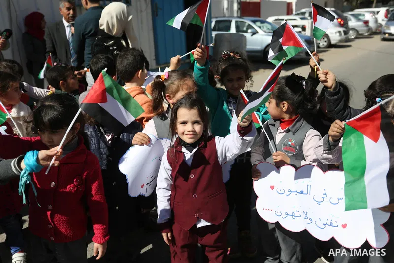 Palestinian children hold banners during a protest against U.S. President Donald Trump's decision to recognise Jerusalem as the capital of Israel, in front of the high commissioner for human rights headquarters, in Gaza...