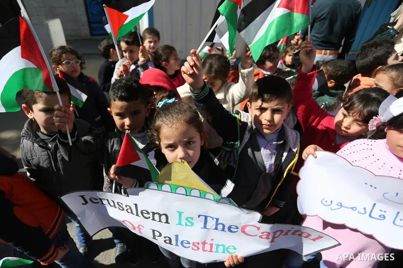 Palestinian children hold banners during a protest against U.S. President Donald Trump's decision to recognise Jerusalem as the capital of Israel, in front of the high commissioner for human rights headquarters, in Gaza...