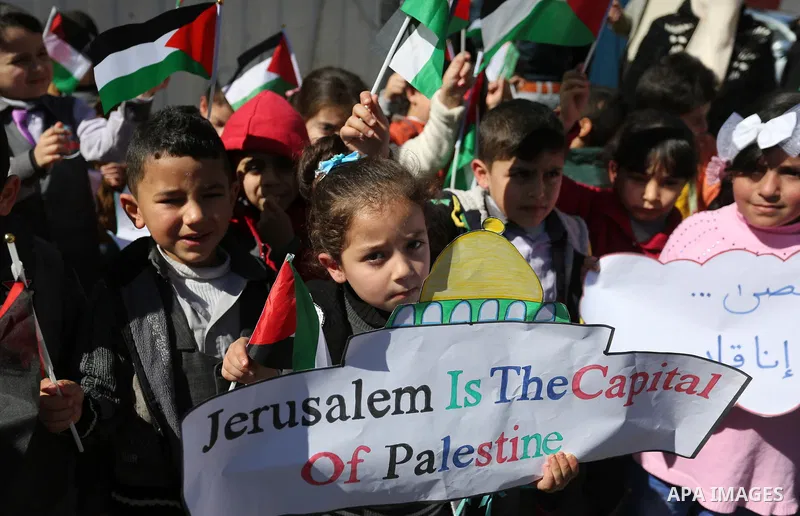 Palestinian children hold banners during a protest against U.S. President Donald Trump's decision to recognise Jerusalem as the capital of Israel, in front of the high commissioner for human rights headquarters, in Gaza...