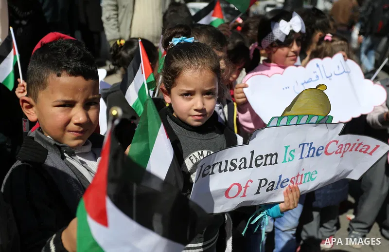 Palestinian children hold banners during a protest against U.S. President Donald Trump's decision to recognise Jerusalem as the capital of Israel, in front of the high commissioner for human rights headquarters, in Gaza...