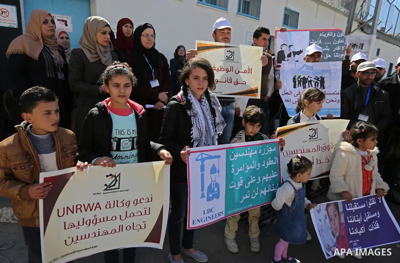 Palestinians take part in a protest against a U.S. decision to cut aid, in front of the headquarters United Nations Relief and Works Agency (UNRWA) in Gaza city on February 28, 2018. Photo by Ashraf Amra