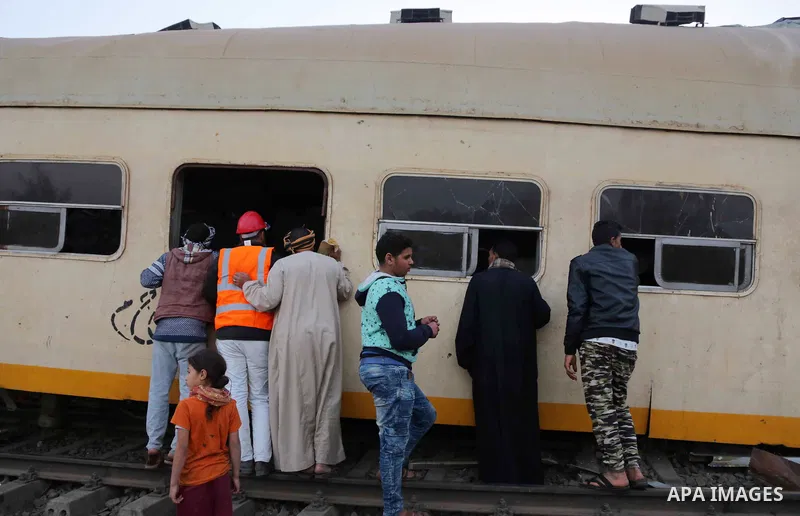 Egyptians gather at the scene of a train collision near Kom Hamadah, in the Beheira province in the Nile delta, Egypt on February 28, 2018. The death toll of the train crash that took place in Beheira province northern t...