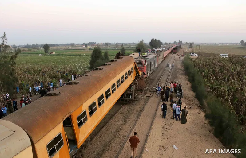 Egyptians gather at the scene of a train collision near Kom Hamadah, in the Beheira province in the Nile delta, Egypt on February 28, 2018. The death toll of the train crash that took place in Beheira province northern t...