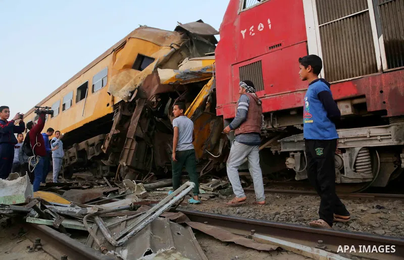 Egyptians gather at the scene of a train collision near Kom Hamadah, in the Beheira province in the Nile delta, Egypt on February 28, 2018. The death toll of the train crash that took place in Beheira province northern t...