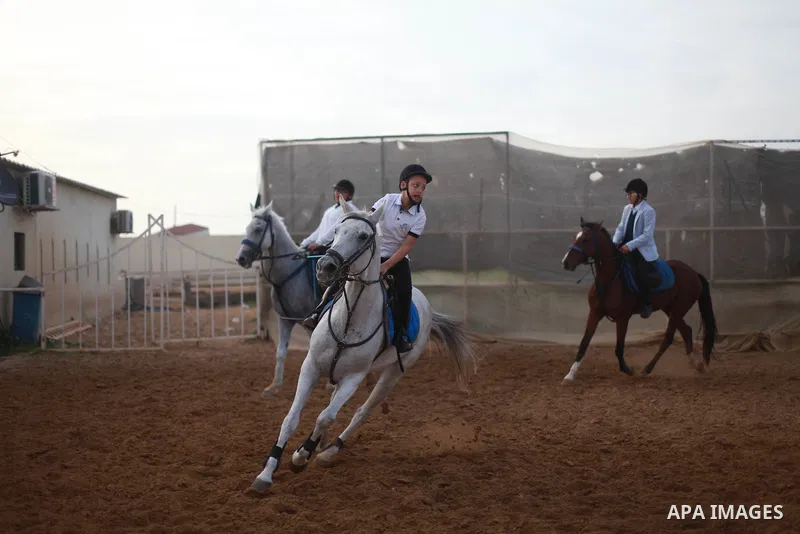 A Palestinian boy rides his horse during a local jumping competition "friends challenge" in Gaza city on March 2, 2018. Photo by Mahmoud Ajour