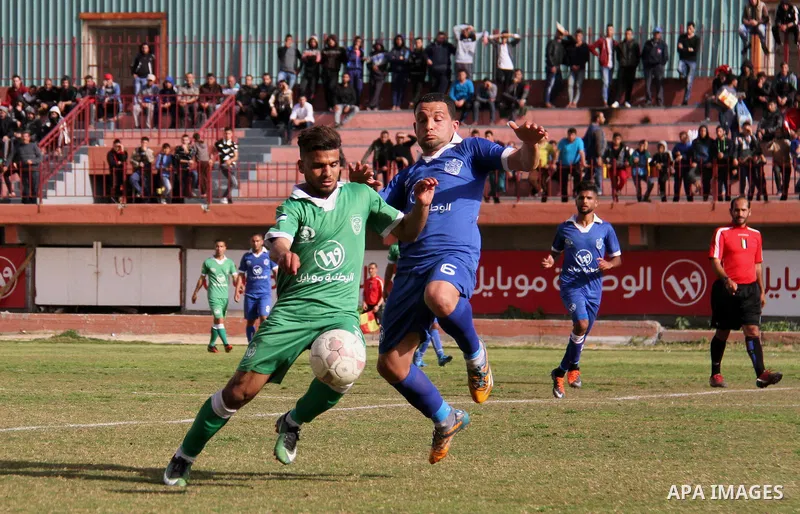 Palestinian Shabab Rafah football club players (in blue) and Shejaiya's football club players (in green) compete during a football match at Palestine Stadium in Gaza city on March 4, 2018. Photo by Mahmoud Ajour