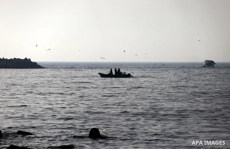 Palestinian fishermen ride their boat in the sea of Gaza city during sunset on March 5, 2018. Photo by Yasser Qudih