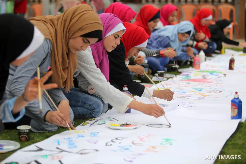 Palestinian girls take part in a celebrate on the occasion of International Women's Day in Gaza city, March 8, 2018. Photo by Ashraf Amra