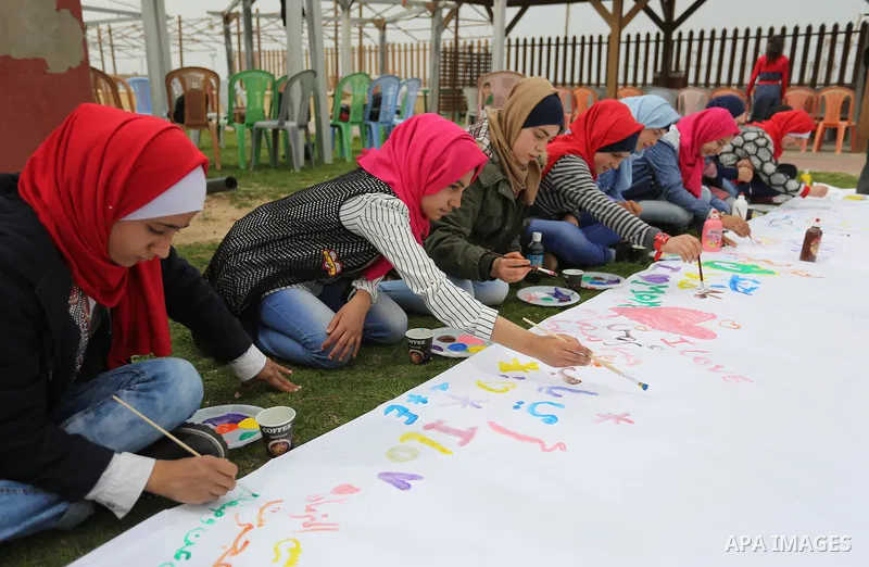 Palestinian girls take part in a celebrate on the occasion of International Women's Day in Gaza city, March 8, 2018. Photo by Ashraf Amra