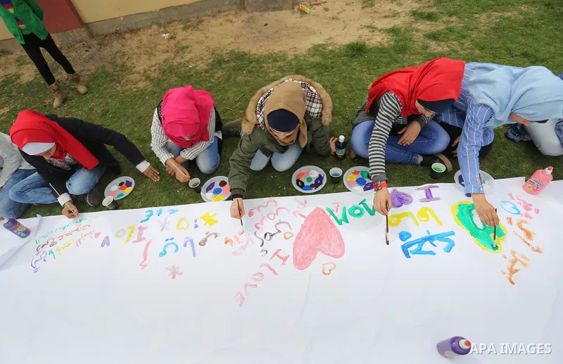 Palestinian girls take part in a celebrate on the occasion of International Women's Day in Gaza city, March 8, 2018. Photo by Ashraf Amra
