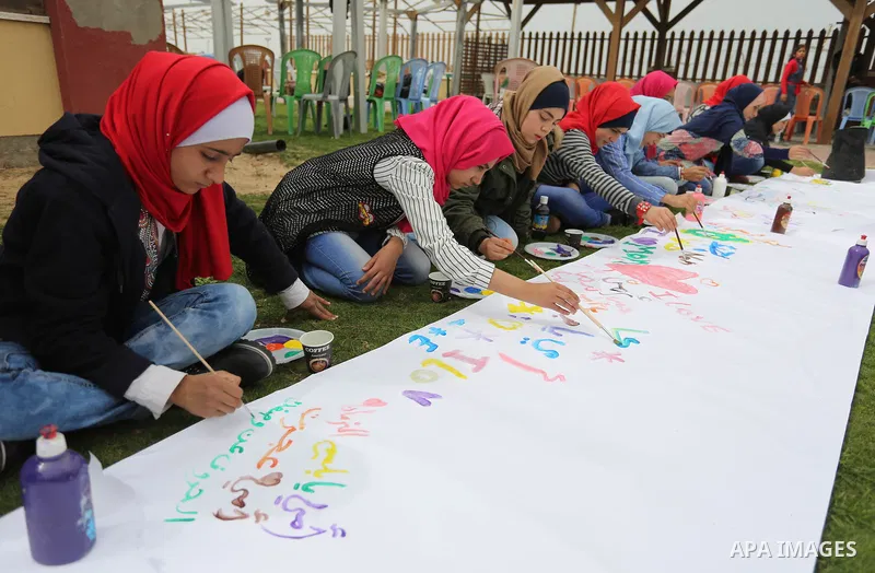 Palestinian girls take part in a celebrate on the occasion of International Women's Day in Gaza city, March 8, 2018. Photo by Ashraf Amra