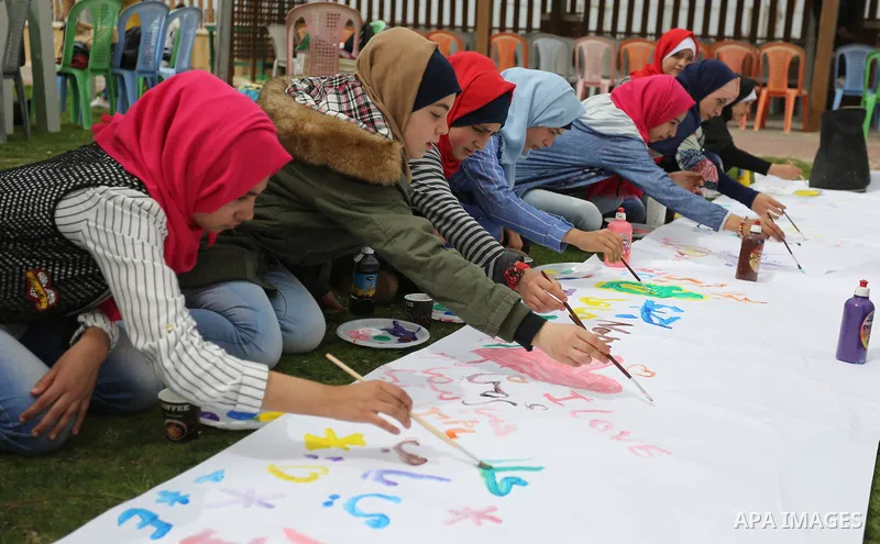 Palestinian girls take part in a celebrate on the occasion of International Women's Day in Gaza city, March 8, 2018. Photo by Ashraf Amra