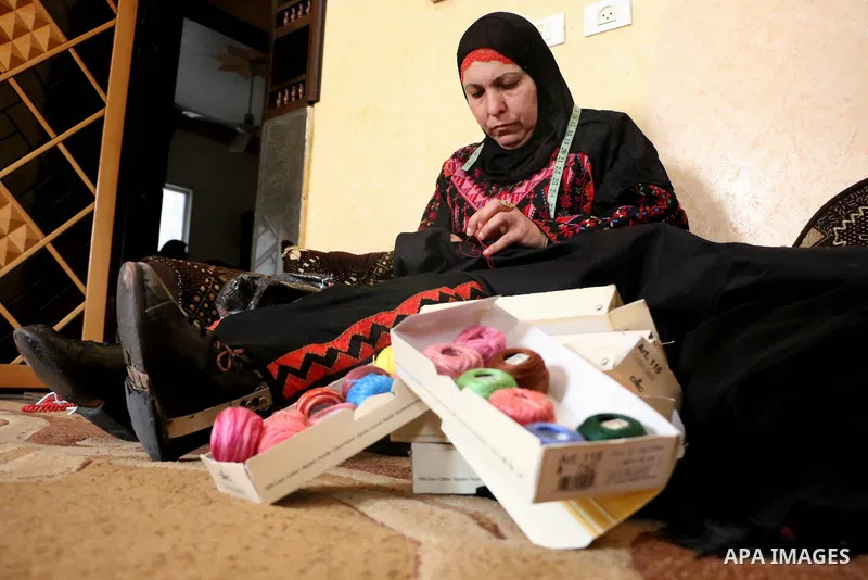 Jihad Awad, 50, a Palestinian woman of special needs, works on embroidery on the occasion of International Women's Day, in al-Bureij refugee camp, in the center of Gaza strip, on March 8, 2018. International Women’s Day...