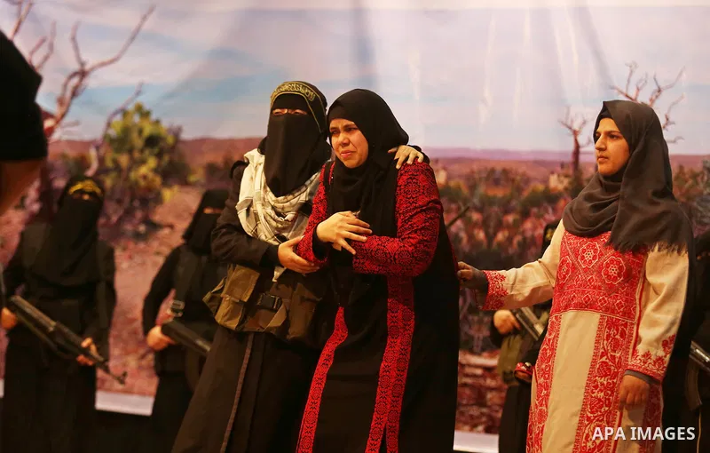 Palestinian women supporters of Islamic Jihad hold weapons during a Stage show in a celebrate on the occasion of International Women's Day in Gaza city, March 10, 2018. Photo by Ashraf Amra. Photo by Ashraf Amra