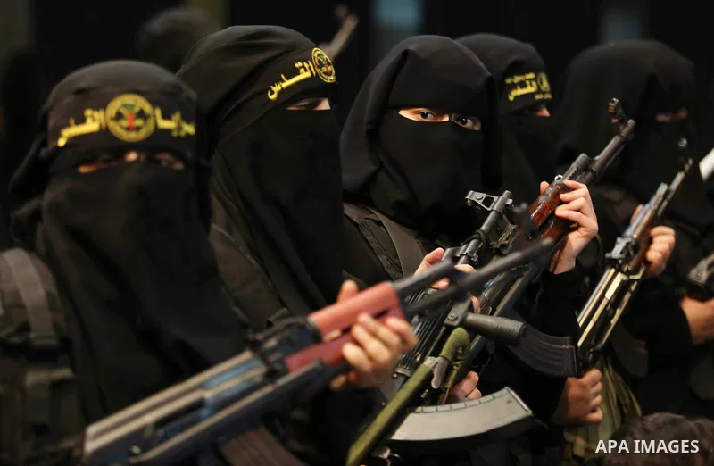 Palestinian women supporters of Islamic Jihad hold weapons during a Stage show in a celebrate on the occasion of International Women's Day in Gaza city, March 10, 2018. Photo by Ashraf Amra. Photo by Ashraf Amra