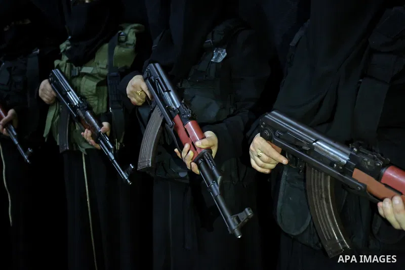 Palestinian women supporters of Islamic Jihad hold weapons during a Stage show in a celebrate on the occasion of International Women's Day in Gaza city, March 10, 2018. Photo by Ashraf Amra. Photo by Ashraf Amra