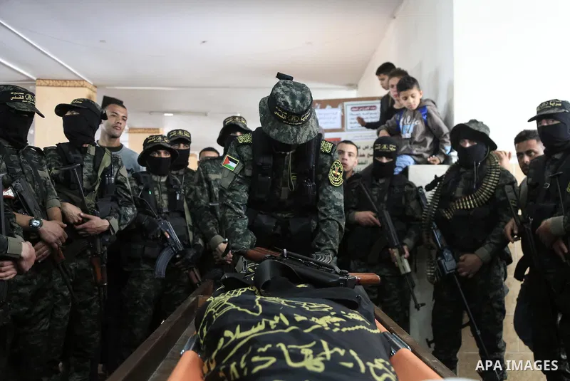 Palestinian militants from the Al-Quds Brigades, the armed wing of the Islamic Jihad movement mourn over the body of their comrade Ibrahim Farhat, 29, who was died yesterday in an explosion during his funeral in Beit lah...
