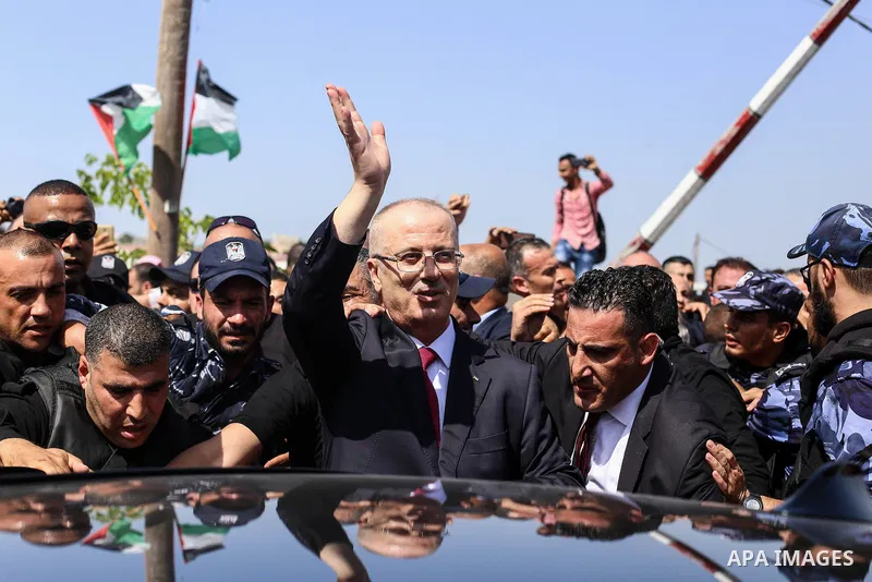 (FILES) In this file photo taken on October 2, 2017 shows Palestinian prime minister Rami Hamdallah is surrounded by security as he arrives at the Erez border crossing in the northern Gaza Strip. An explosion has struck...