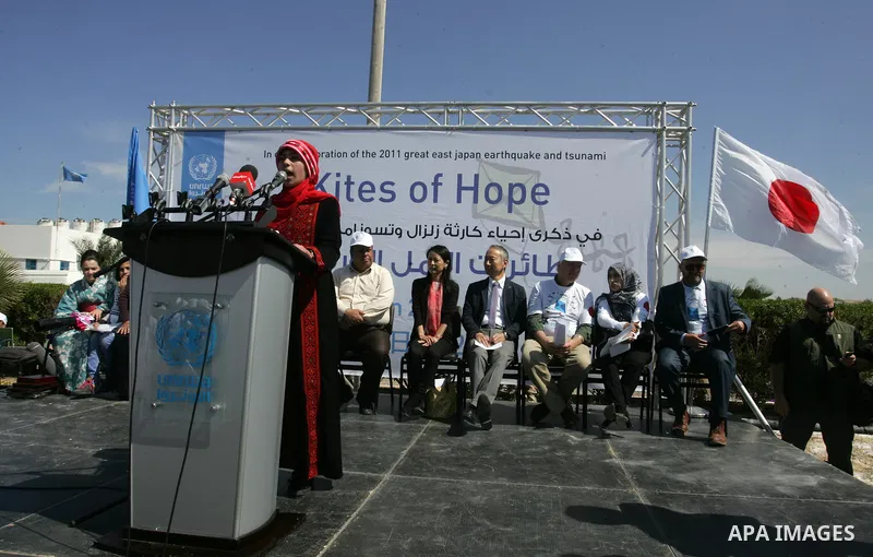 Matthias Schmale, Director of United Nations Relief and Works Agency (UNRWA) Operations in Gaza and Japanese ambassador for Palestinian Affairs, Takeshi Okubo attend a show of solidarity with the Japanese people in the s...