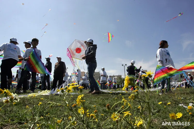 Palestinian school children fly kites in a show of solidarity with the Japanese people in the southern Gaza Strip town of Khan Yunis on March 13, 2018, during an event organised by the United Nations Relief and Works Age...