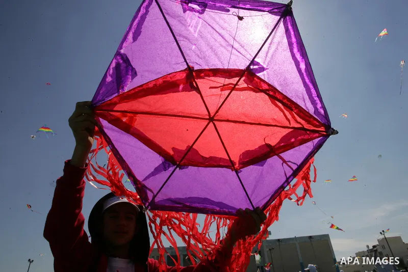 Palestinian school children fly kites in a show of solidarity with the Japanese people in the southern Gaza Strip town of Khan Yunis on March 13, 2018, during an event organised by the United Nations Relief and Works Age...