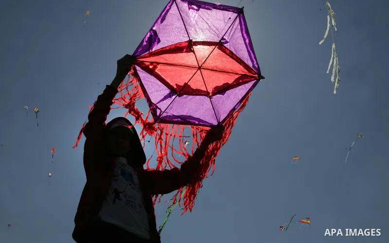 Palestinian school children fly kites in a show of solidarity with the Japanese people in the southern Gaza Strip town of Khan Yunis on March 13, 2018, during an event organised by the United Nations Relief and Works Age...