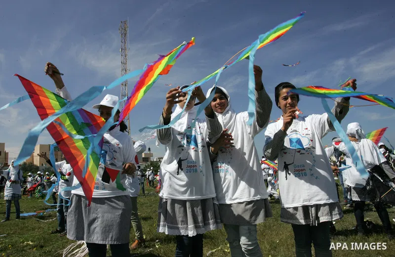 Palestinian school children fly kites in a show of solidarity with the Japanese people in the southern Gaza Strip town of Khan Yunis on March 13, 2018, during an event organised by the United Nations Relief and Works Age...
