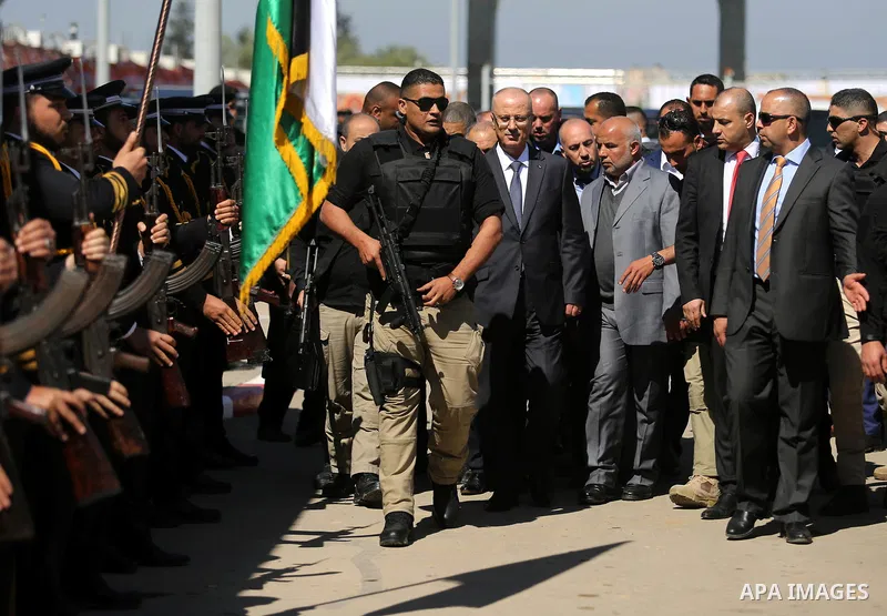 Palestinian Prime Minister Rami Hamdallah escorted by his bodyguards, upon his arrival to attend the inauguration ceremony of a waste treatment plant after an explosion targeted his convoy, in the northern Gaza Strip Mar...