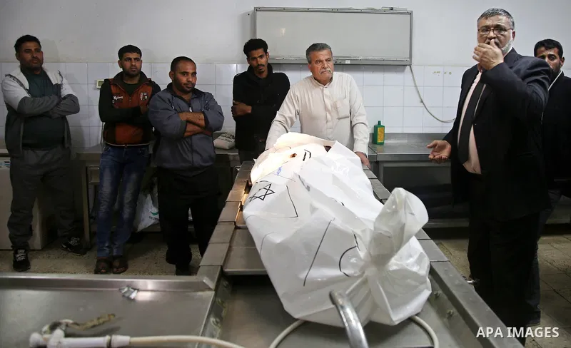 Relatives mourn over the body of a Palestinian fisherman Ismail Abu Riala, 18, who was shot dead by Israeli Naval forces on February 14, after Israeli High Court decided to release his body at al-Shifa hospital, in Gaza...