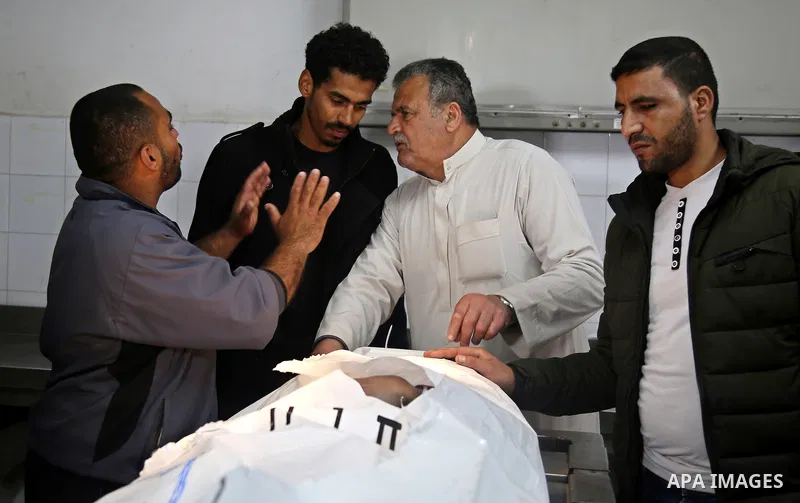 Relatives mourn over the body of a Palestinian fisherman Ismail Abu Riala, 18, who was shot dead by Israeli Naval forces on February 14, after Israeli High Court decided to release his body at al-Shifa hospital, in Gaza...
