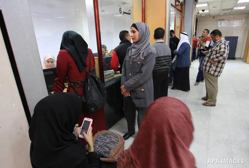 A Palestinian woman security guard from Secure Land company for security and logistics services takes part in a work day at bank of Palestine in Gaza City on March 19, 2018. Secure land is the first security company for...