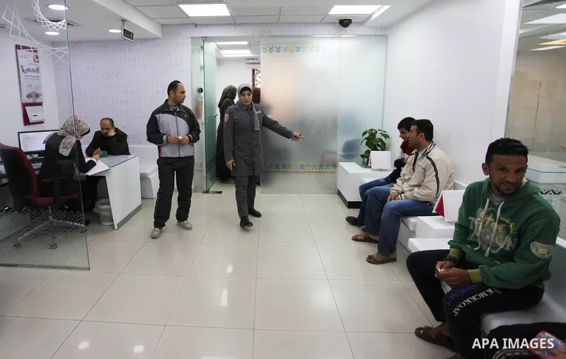 A Palestinian woman security guard from Secure Land company for security and logistics services takes part in a work day at bank of Palestine in Gaza City on March 19, 2018. Secure land is the first security company for...