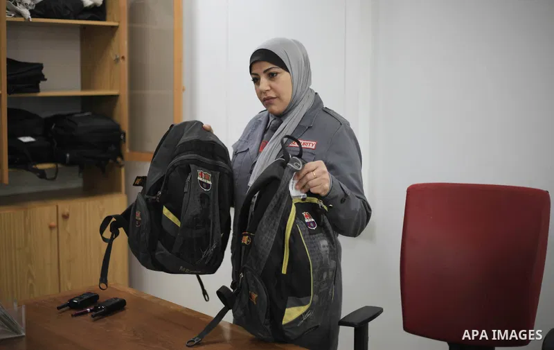 A Palestinian woman security guard from Secure Land company for security and logistics services takes part in a work day at bank of Palestine in Gaza City on March 19, 2018. Secure land is the first security company for...