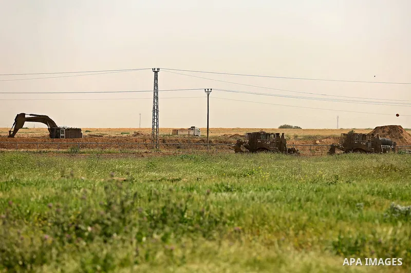 Israeli military vehicles are seen near the border fence between Israel and east of Gaza city on March 21, 2018 . Photo by Dawoud Abo Alkas