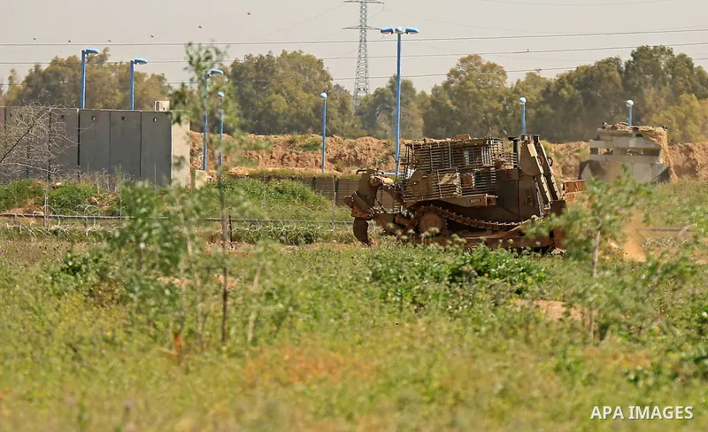 Israeli military vehicles are seen near the border fence between Israel and east of Gaza city on March 21, 2018 . Photo by Dawoud Abo Alkas