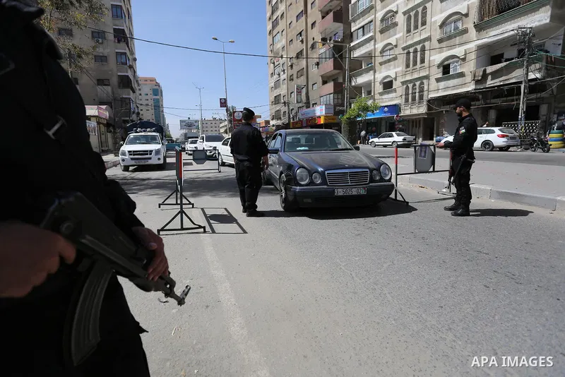 Palstinian policemen inspect the trunk of a car at a checkpoint as they tighten security around Gaza city, on March 22, 2018 Hamas has named a fugitive suspect in a bomb attack on Palestinian prime minister Rami Hamdalla...