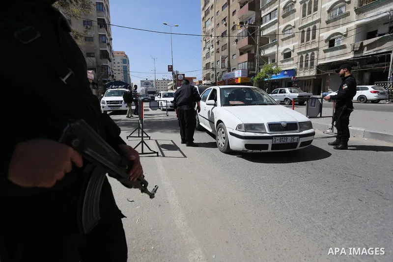 Palstinian policemen inspect the trunk of a car at a checkpoint as they tighten security around Gaza city, on March 22, 2018 Hamas has named a fugitive suspect in a bomb attack on Palestinian prime minister Rami Hamdalla...