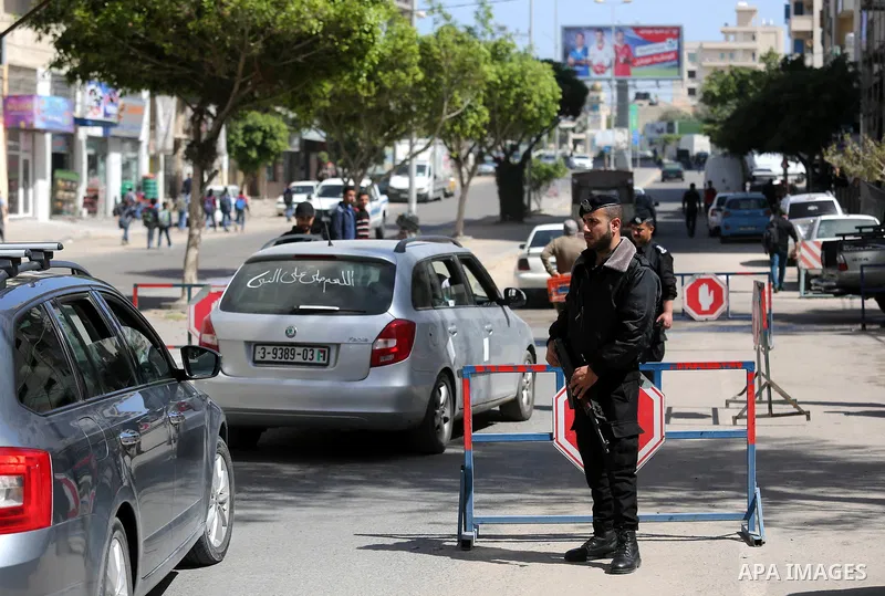 Palstinian policemen inspect the trunk of a car at a checkpoint as they tighten security around Gaza city, on March 22, 2018 Hamas has named a fugitive suspect in a bomb attack on Palestinian prime minister Rami Hamdalla...