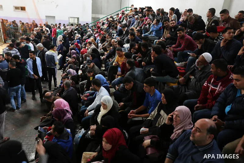 Palestinians wait for travel permits to cross into Egypt through the Rafah border crossing after it was opened by Egyptian authorities for humanitarian cases, in Khan Yunis in the southern Gaza Strip on March 24, 2018. P...