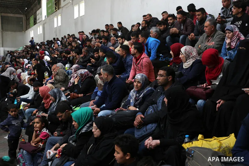 Palestinians wait for travel permits to cross into Egypt through the Rafah border crossing after it was opened by Egyptian authorities for humanitarian cases, in Khan Yunis in the southern Gaza Strip on March 24, 2018. P...